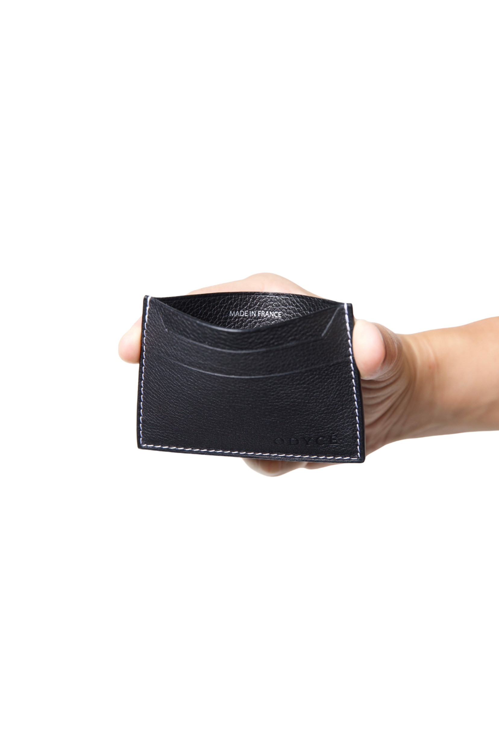 ODYCÉ Kartenhalter Schwarz in der Hand